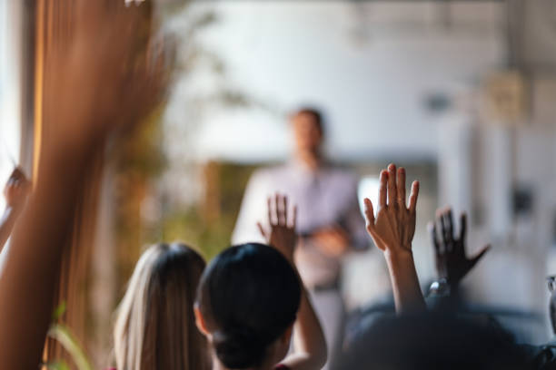 istock Audience Engaging in a Business Conference with Raised Hands 2179684487