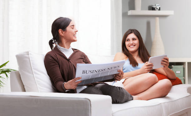 istock Mother and daughter sharing quality time reading relaxing on sof 2179688629