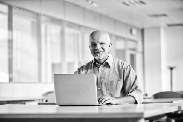 istock Mature businessman working on laptop in modern office 2179688634