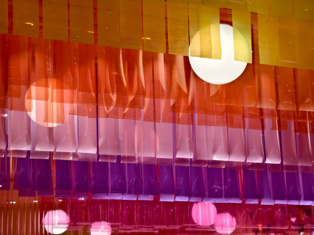A beautifully colorful ceiling with a light fixture hanging from it