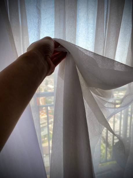istock Pulling Back the White Curtains, on the Apartment Balcony with City View 2179690756