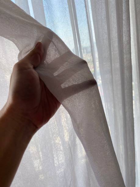 istock Pulling Back the White Curtains, on the Apartment Balcony with City View 2179690776