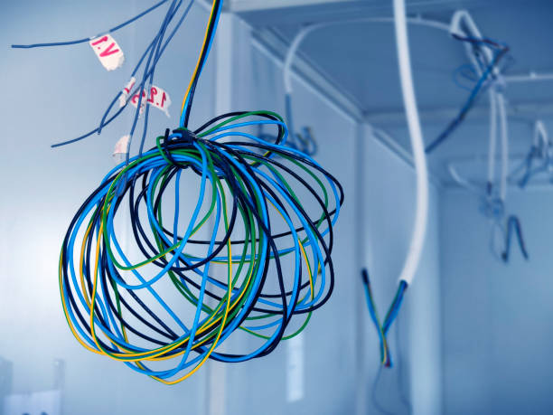 istock A collection of various wires is hanging down from the ceiling 2179692205