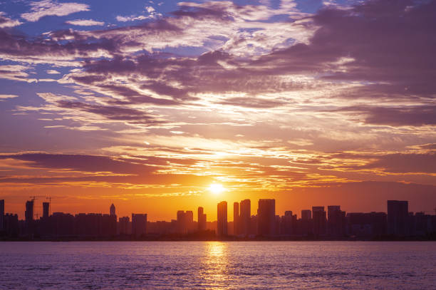 Sunset over the modern urban skyline with dramatic sky and clouds