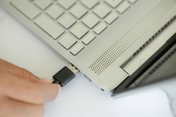 istock A person is plugging in a USB cable into a laptop 2179693578