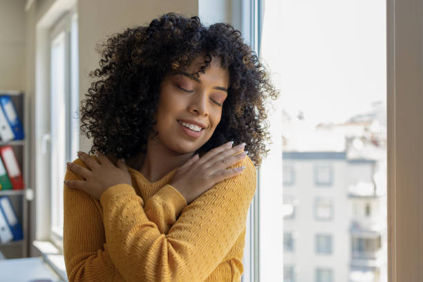 istock Beautiful woman hugging self in front of mirror 2179694781