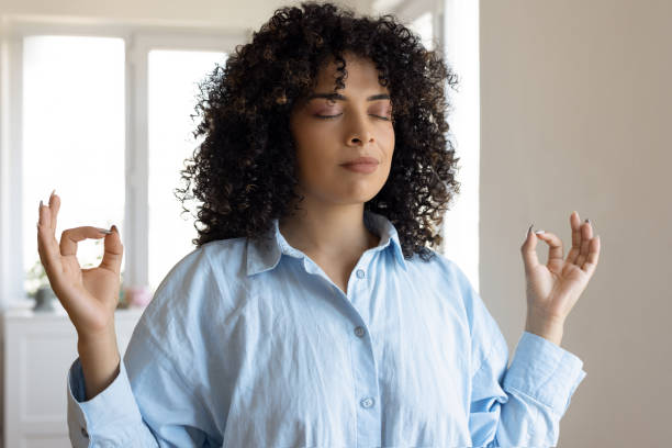 istock Young woman meditating peacefully 2179694889