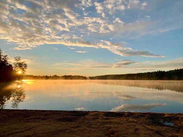 istock Misty Sunrise Over Still Lake: A Serene Morning Scene 2179695227