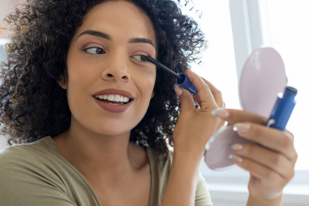 istock Young woman applying mascara 2179696214