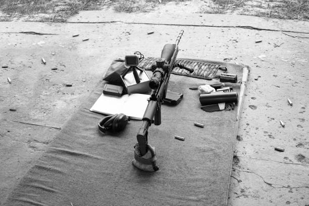 adjustments of a sniper rifle scope on the fire range, in black and white