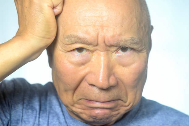 Portrait of a bald man on a background of a wooden wall
