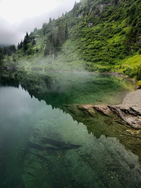 Misty lake in the swiss alps captured during summer season at an altitude of 1700m in the canton of glarus.