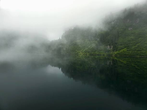 Misty lake in the swiss alps captured during summer season at an altitude of 1700m in the canton of glarus.