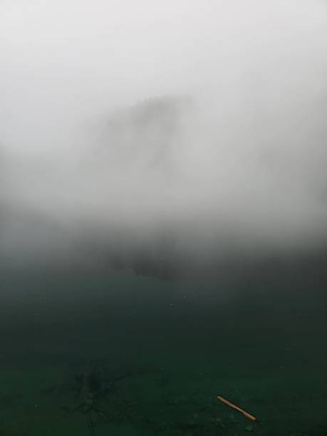 Misty lake in the swiss alps captured during summer season at an altitude of 1700m in the canton of glarus.