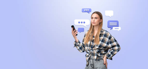 istock Woman holding smartphone with speech bubbles on light blue backg 2179700940