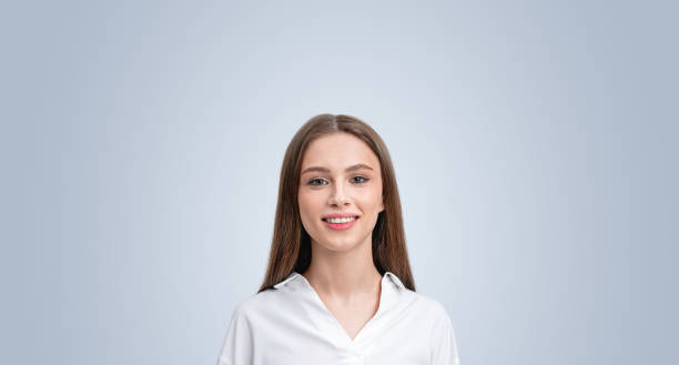 istock Smiling woman student on grey copy space empty background 2179701119