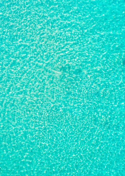 istock Ripple of blue Water with sun reflection on beach 2179701220