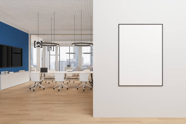 istock Cozy office interior with meeting table and tv screen, window and mockup frame 2179701790