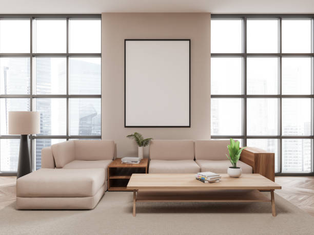 istock Modern living room featuring a blank framed poster on the wall, beige sofas, a wooden coffee table, and a tall lamp. Bright cityscape background, concept of interior design. 3D Rendering 2179702009