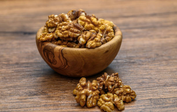istock Fresh shelled golden walnut halves with skin 2179703157