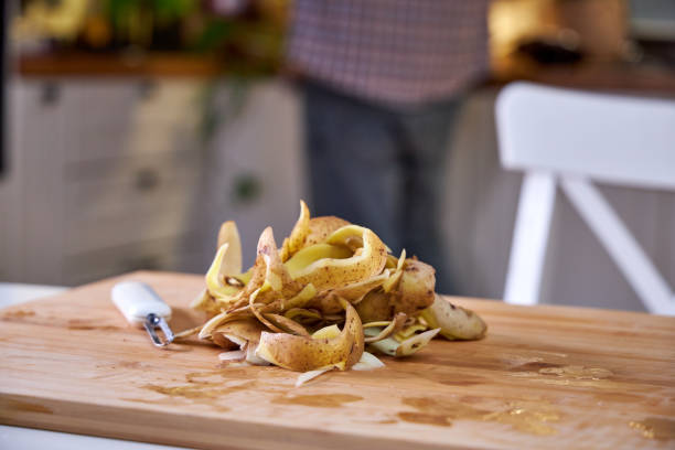 peeled potatoes on a cutting board in the kitchen