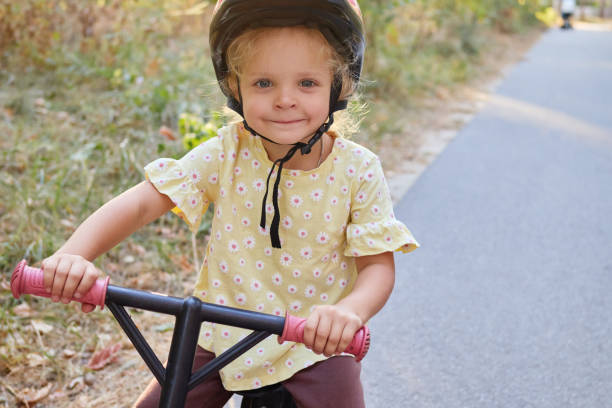 istock Active child riding bicycle in park enjoying thrill of cycling developing balance and coordination during summer playtime outdoors 2179707013