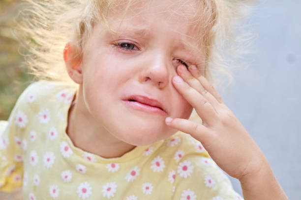 a little girl is crying. Selective focus.