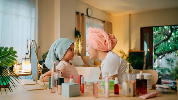 istock Mother and daughter sharing a joyful conversation during beauty routine. 2179709047
