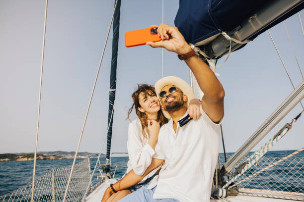 Couple taking a selfie on a sailing boat during vacation