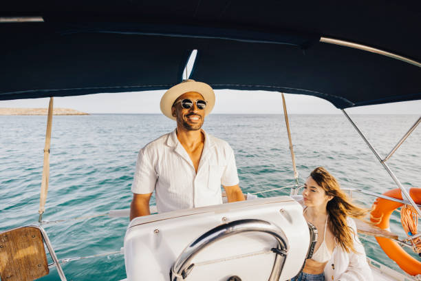 istock Couple enjoying a sunny day sailing on the open sea 2179710302