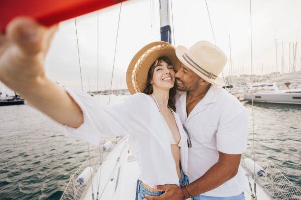 istock Couple taking a selfie on a sailboat during a sunny day 2179710415