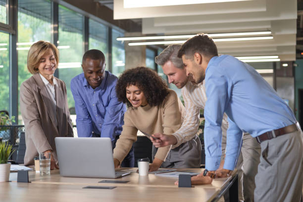 istock Successful businesspeople working in a coworking space working with laptop discussing strategy and business plan in modern office. 2179710634