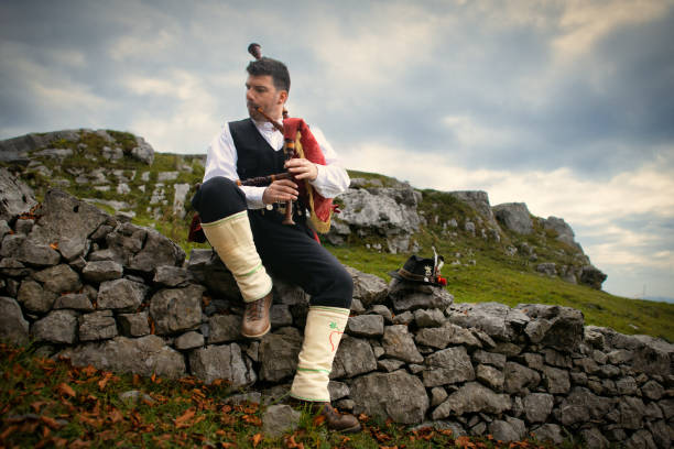 Bagpipe player in rural mountain location In Northern Italy