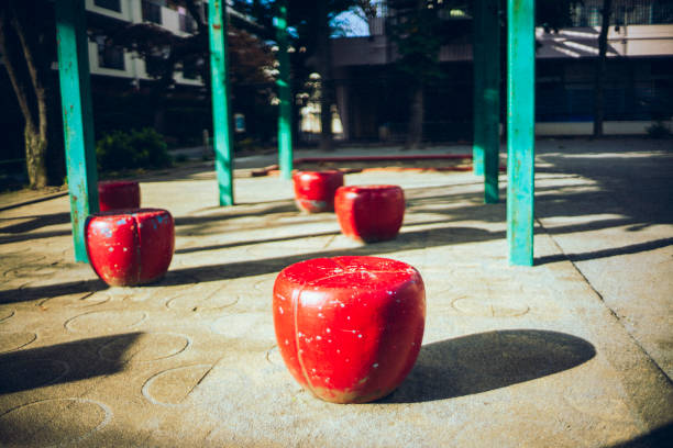 Cute red chairs in the children's park.