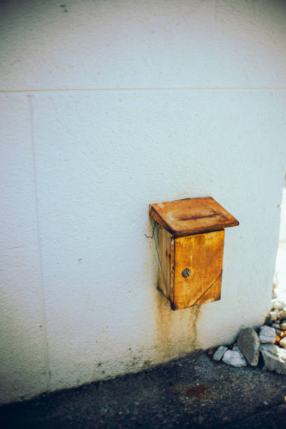 Old house electric panel, electric panel hanging on the old and abandoned building exterior