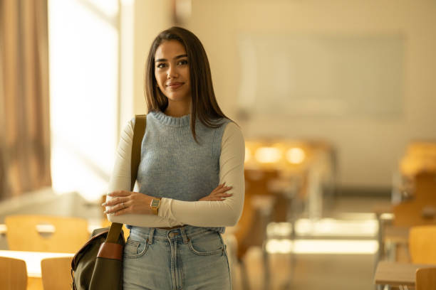 istock Portrait of beautiful female student in empty classroom 2179718173