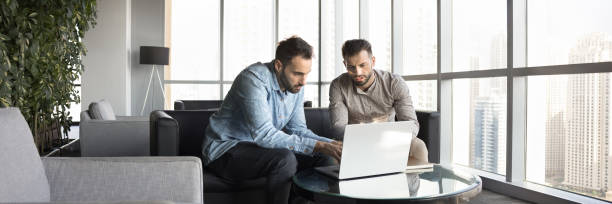 istock Two focused business professional men working on online project together 2179718529