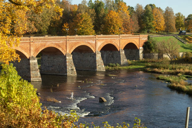 istock Autumn landscape with Kuldiga brick bridge over river Venta in Latvia. 2179719065