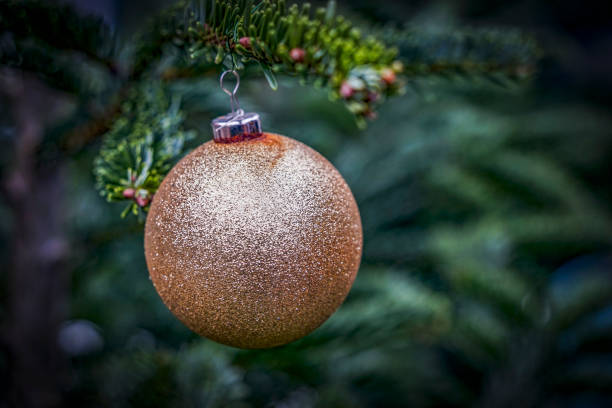 istock Festive Christmas. Single glittering Christmas tree bauble on a Christmas tree 2179727916
