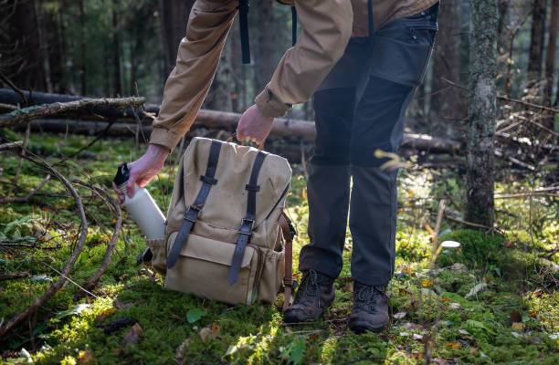 istock Man with a backpack and a bottle of water in the forest. 2179728166
