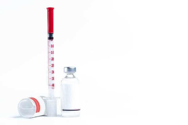 Medical vials and syringe on white background with copy space for text