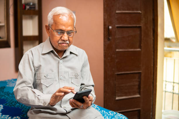 istock Retired senior man sitting in a room and a using smartphone in leisure time. 2179732852