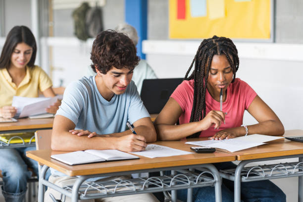 istock African American girl and caucasian guy students talking about class work learning together at school 2179732978