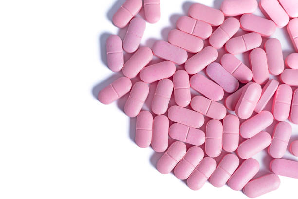 istock pile of pink pills isolated on white background with copy space for text. 2179733376