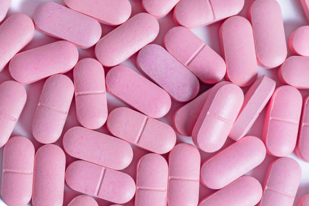 istock Heap of pink pills on white background. 2179733613