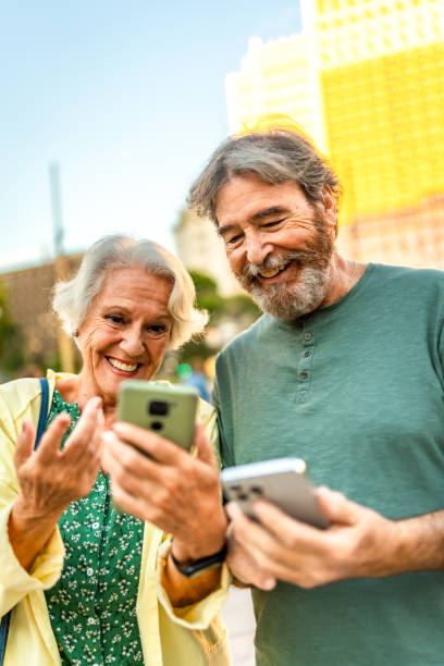 istock Happy modern senior couple using smartphone in the city 2179735727