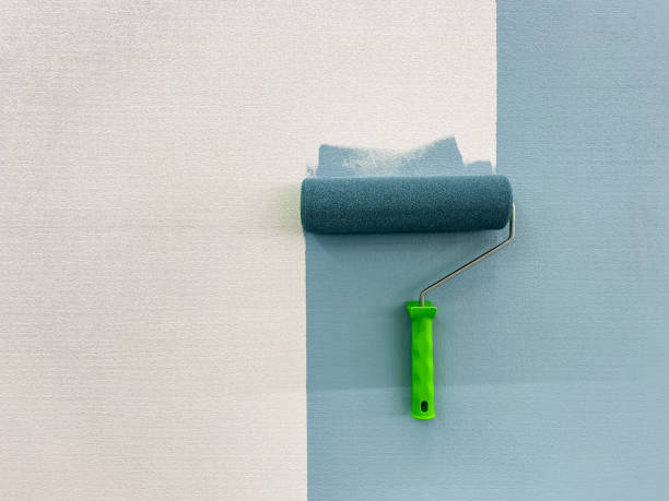 istock A paint roller is actively in use at this moment to efficiently apply paint onto the surface of a wall, which ensures that there is an even and seamless finish along with vibrant color hues 2179739401