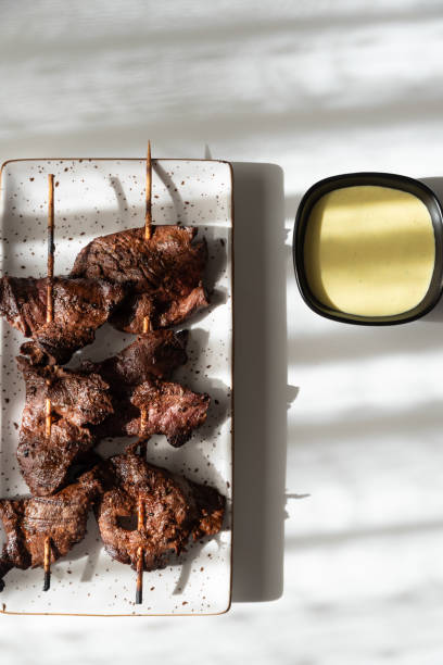 istock Peruvian beef brochettes served with a portion of spicy sauce. 2179740460