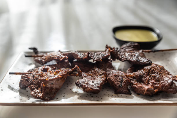 istock Rays of natural light illuminating a typical Peruvian dish called Anticuchos. 2179740471