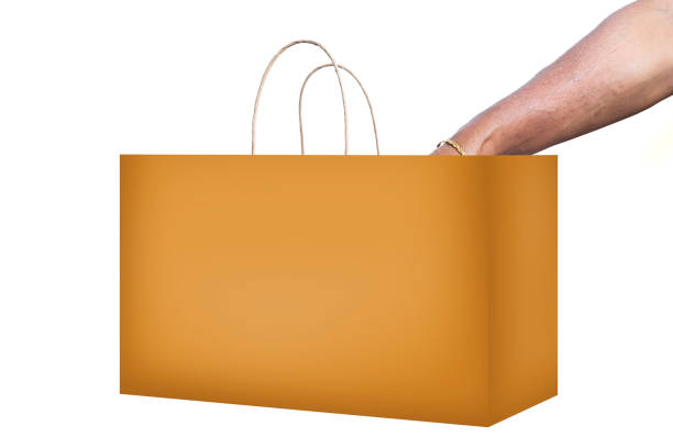 Person with hand inside shopping paper bag against a white background, clipping path